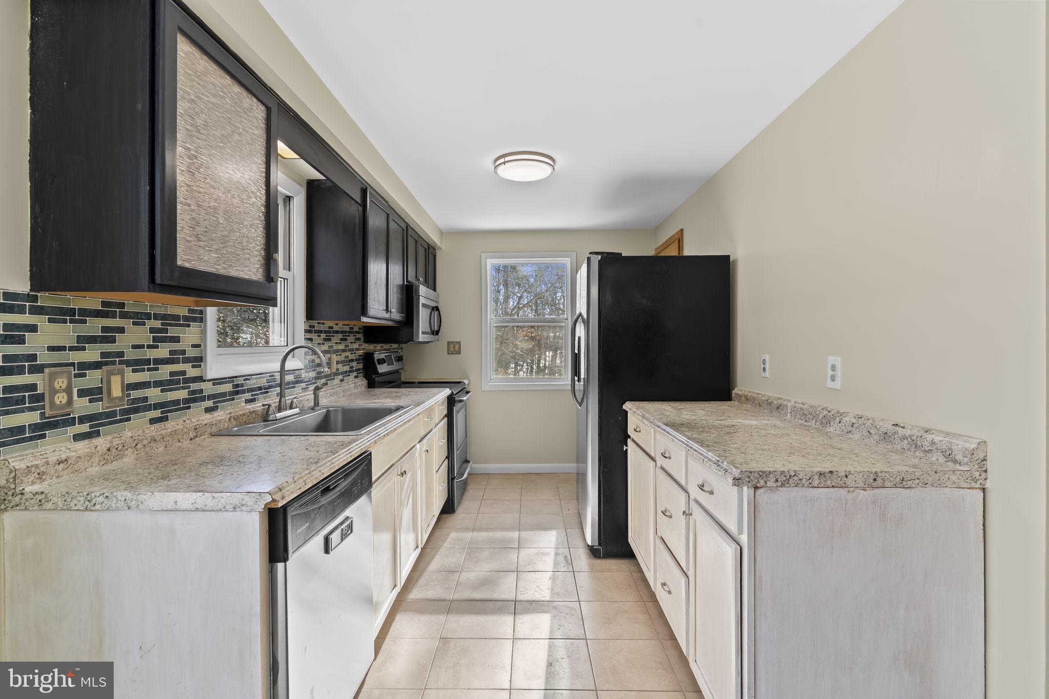 532 Shortbow Trail Lusby, MD 20657 - Photo 10 of 33 a kitchen with a granite countertop refrigerator sink and stove