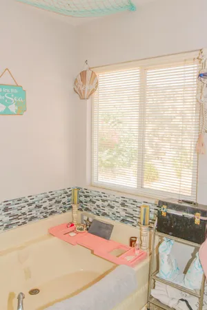 a bath tub sitting in a bathroom next to a window