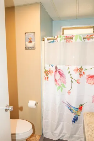 a white toilet sitting next to a white wall