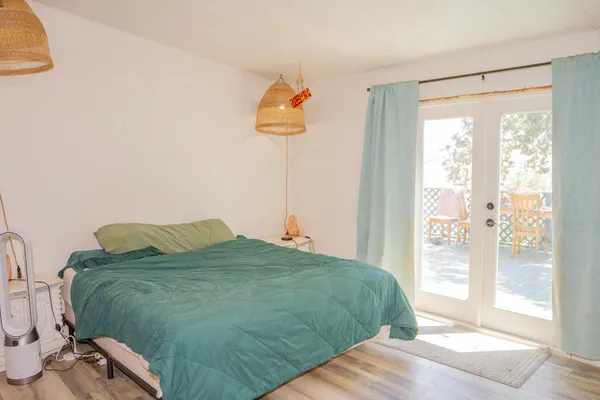 a bedroom with a bed and a window