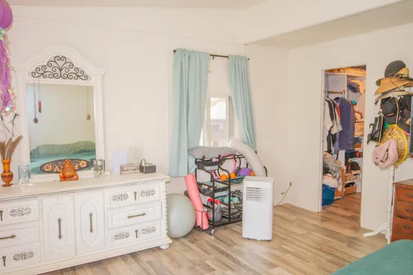 a storage room with wooden floor and white walls