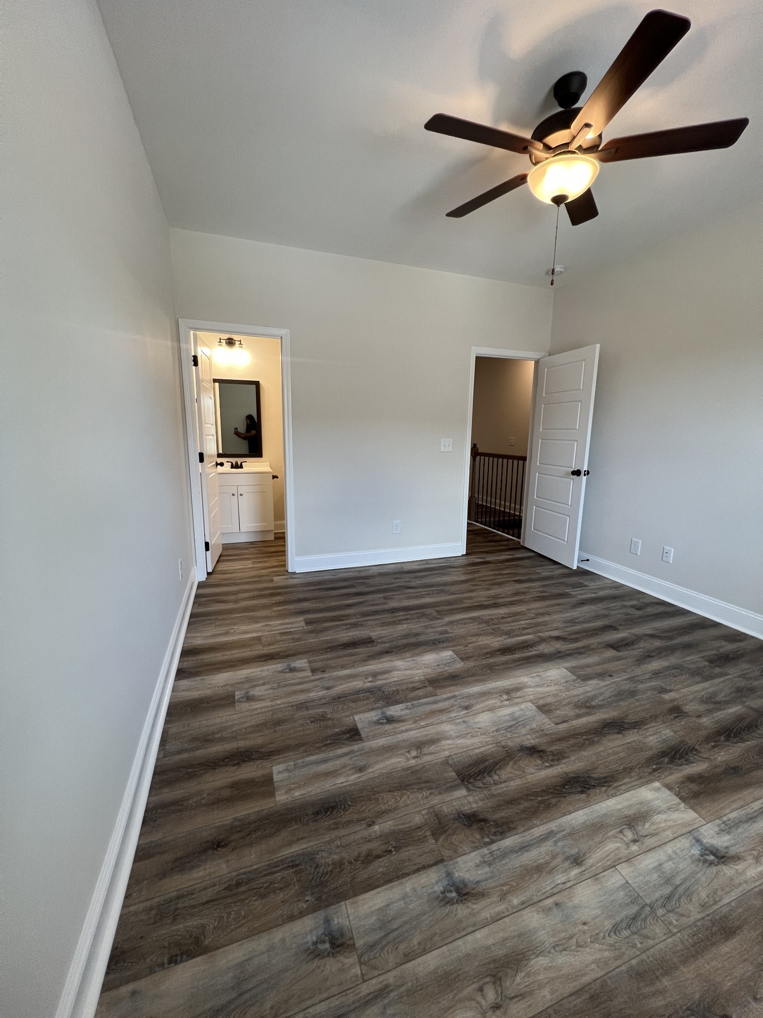 550 Peachers Mill Road, Unit B5 Clarksville, TN 37042 - Photo 23 of 33 a view of a livingroom with wooden floor a ceiling fan and staircase