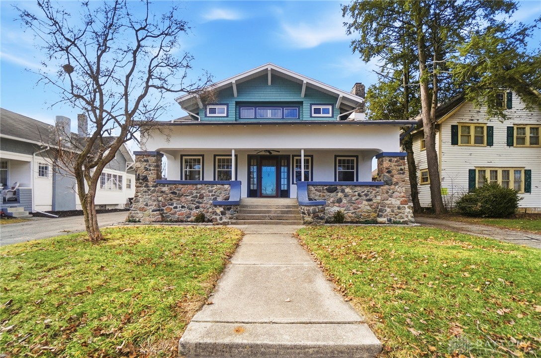 25 Englewood Road Springfield, OH 45504 - Photo 62 of 66 This charming home features a welcoming porch with stone accents, offering a tranquil curb appeal.