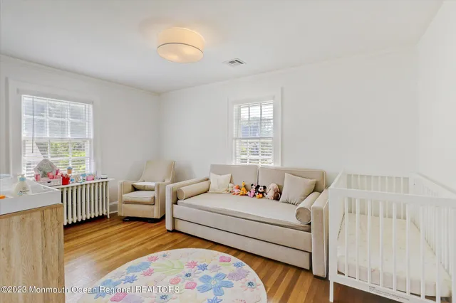 a bedroom with furniture and wooden floor