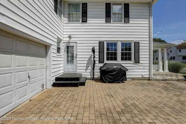 a view of a two chairs in the back yard of the house