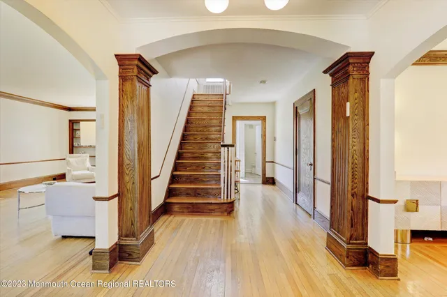 a view of a hallway with wooden floor and staircase