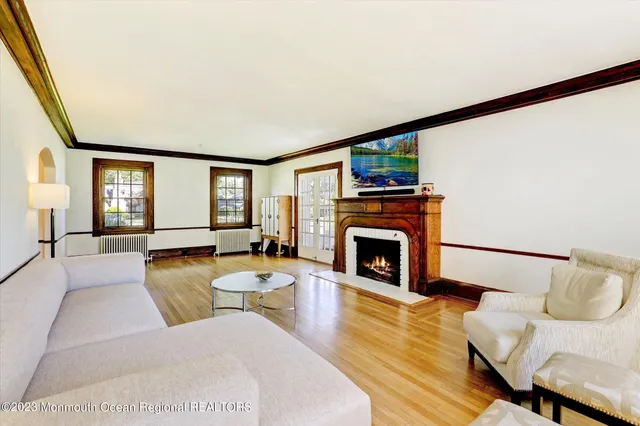 a living room with furniture a fireplace and a flat screen tv
