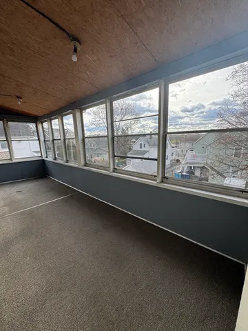 a view of a roof deck with couches and sky view