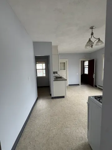 a kitchen with cabinets and window