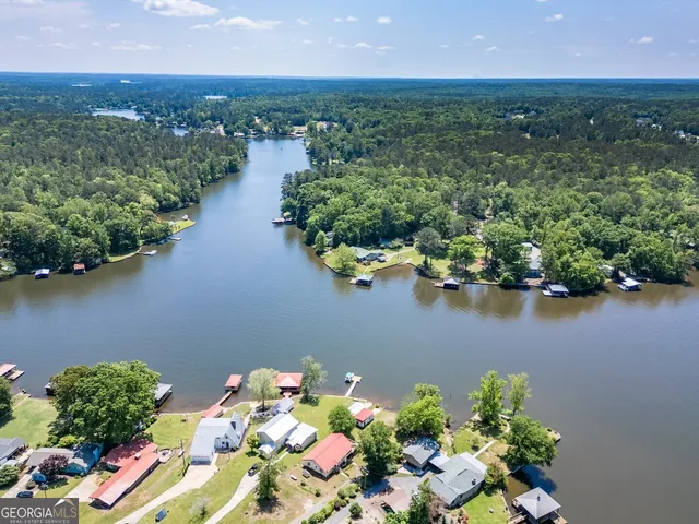 an aerial view of lake and residential houses with outdoor space