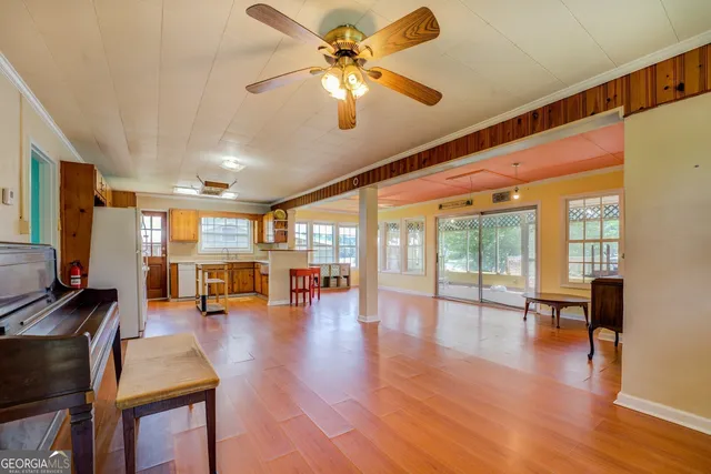 a living room with furniture and wooden floor