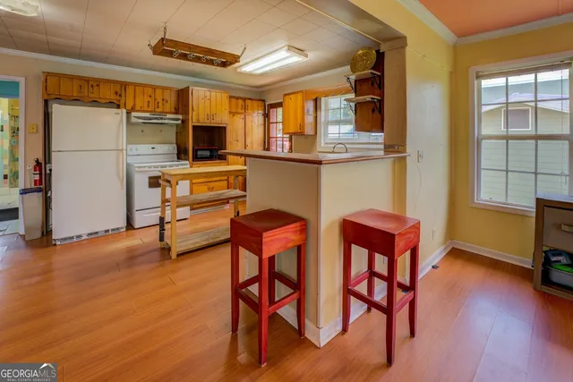 a view of a kitchen with a sink and large windows