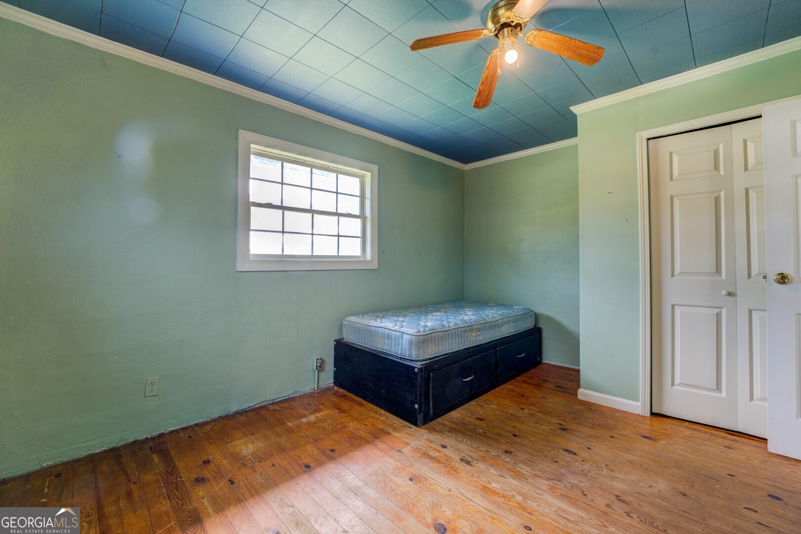 114 Mabry Road Jackson, GA 30233 - Photo 44 of 57 a bedroom with a bed and a chandelier