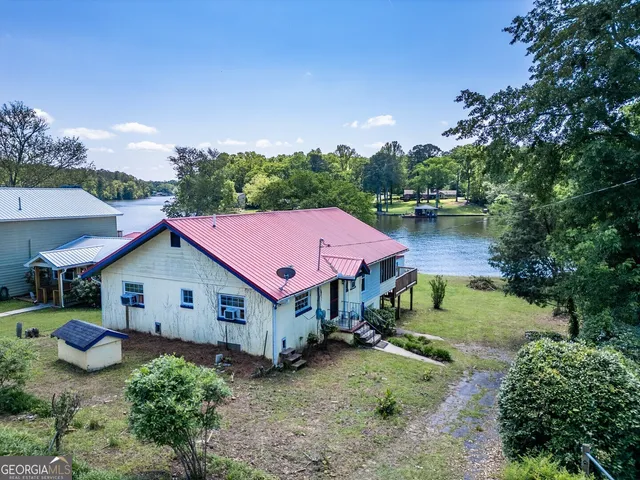 a house with outdoor space swimming pool and lake view