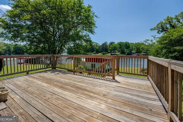 a view of deck with wooden floor and outdoor seating