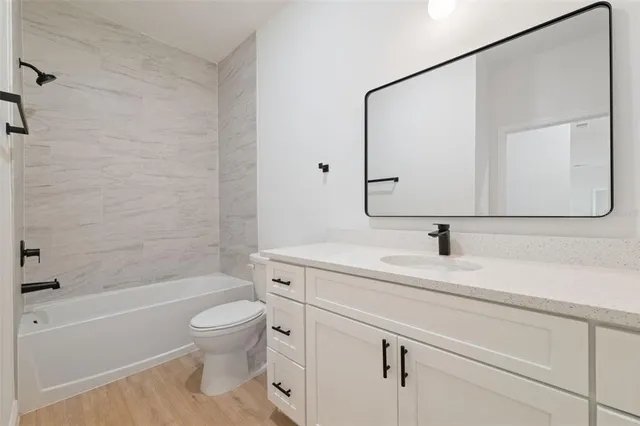 a bathroom with a sink a toilet and a bathtub