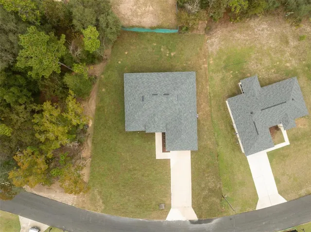 an aerial view of residential house with pool and yard