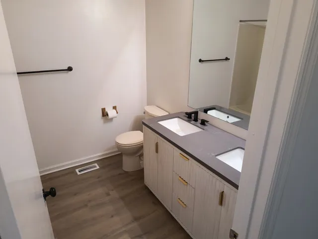 an empty room with wooden floor and window