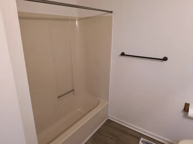 a view of a room with wooden floor