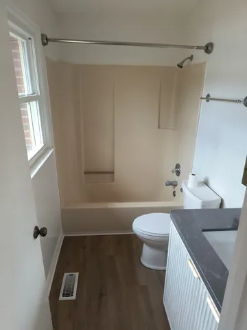 an empty room with wooden floor