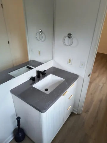 an empty room with wooden floor and entrance