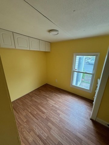 56 Dot's Lane Wareham, MA 02558 - Photo 11 of 28 a view of a room with wooden floor and brick walls