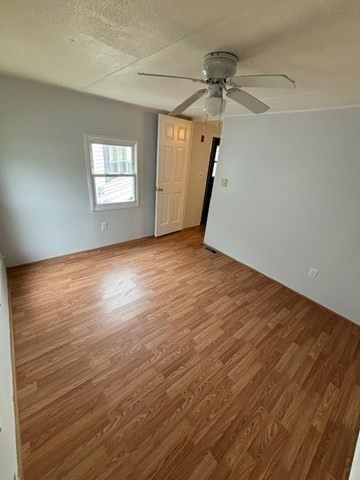 56 Dot's Lane Wareham, MA 02558 - Photo 17 of 28 an empty room with wooden floor fan and windows