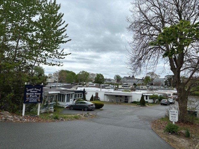 56 Dot's Lane Wareham, MA 02558 - Photo 23 of 28 a view of roof deck with table and chairs couches with wooden fence and plants