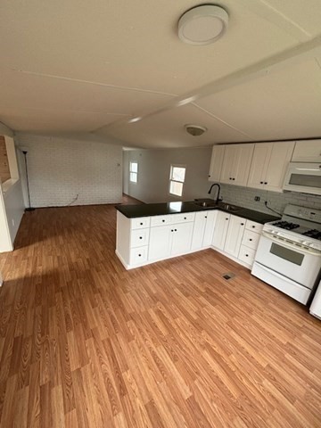 56 Dot's Lane Wareham, MA 02558 - Photo 6 of 28 a kitchen with stainless steel appliances a stove top oven and cabinets