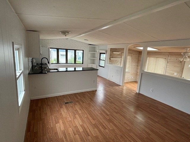 56 Dot's Lane Wareham, MA 02558 - Photo 7 of 28 a view of a living room a kitchen with a wooden floor and a window