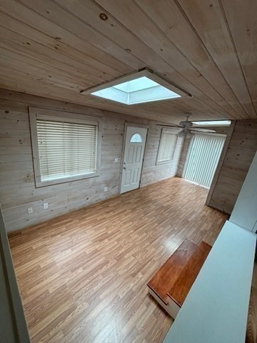 56 Dot's Lane Wareham, MA 02558 - Photo 9 of 28 a view of an empty room with wooden floor and a window
