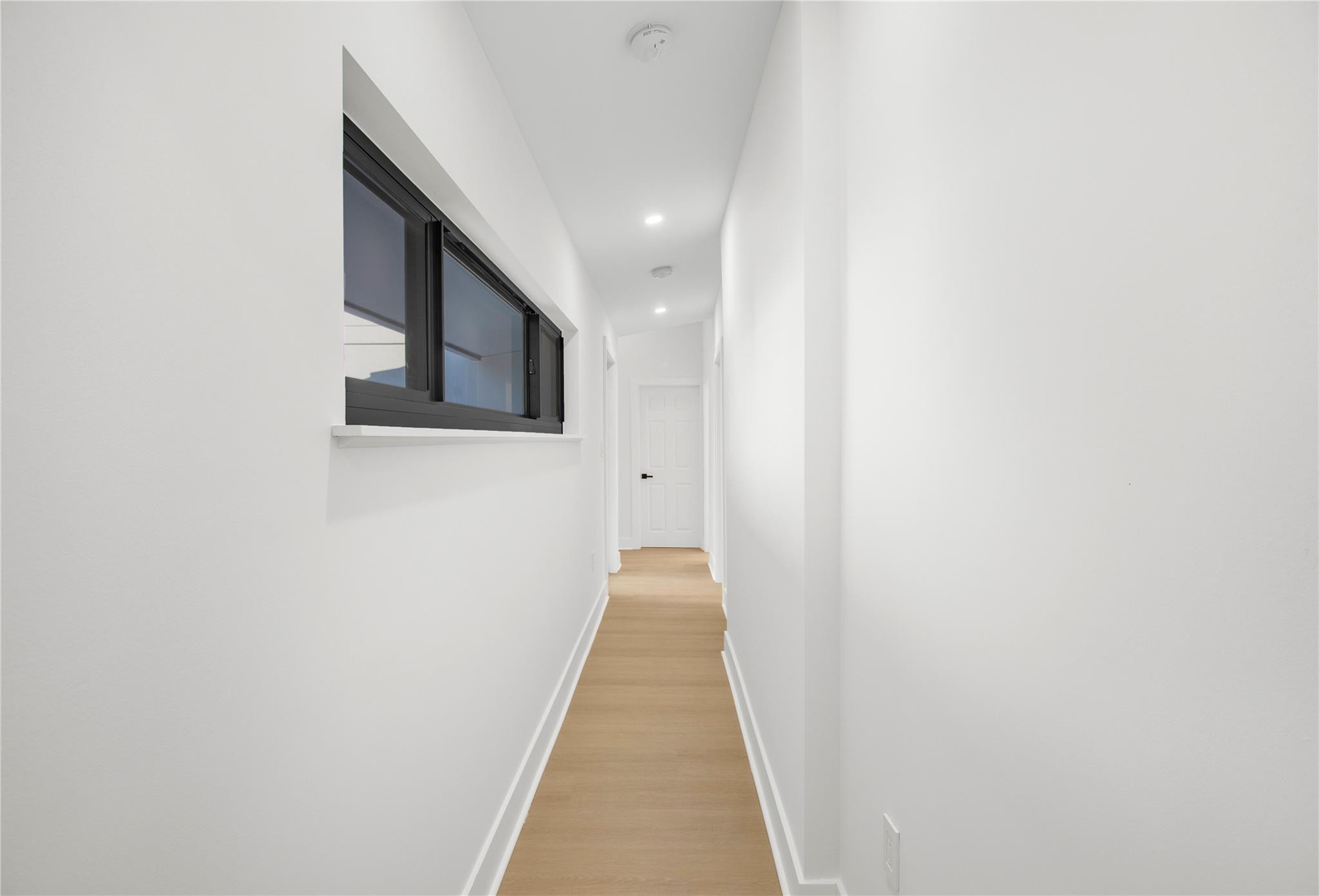 1951 Northeast 28th Court Lighthouse Point, FL 33064 - Photo 13 of 34 a view of a hallway with wooden floor