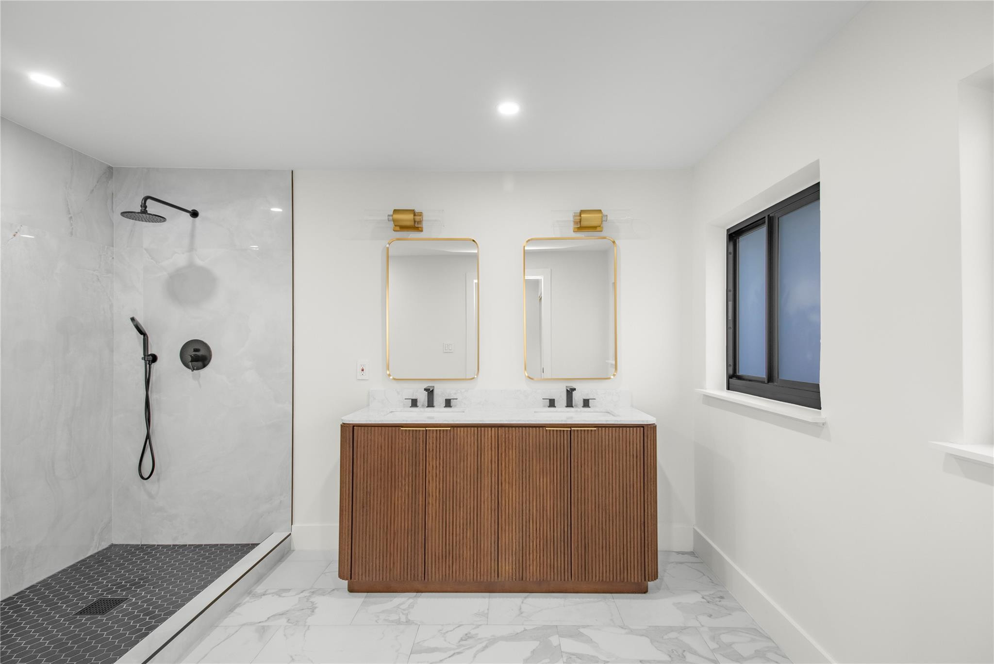 1951 Northeast 28th Court Lighthouse Point, FL 33064 - Photo 5 of 34 a large bathroom with a tub shower and mirror