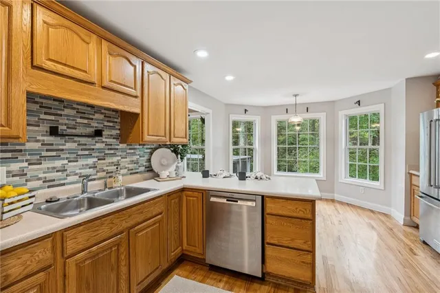 a kitchen with a sink a counter top space and stainless steel appliances