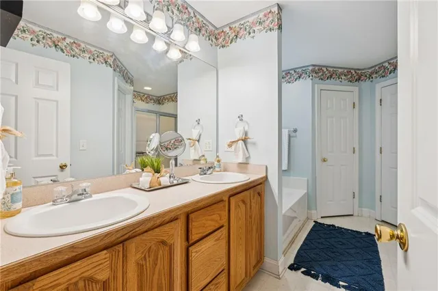 a bathroom with a sink a mirror and a shower