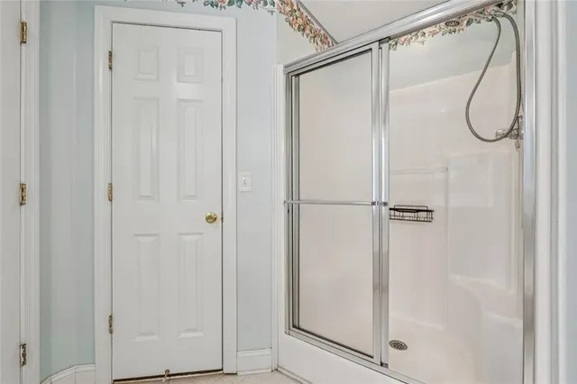 a bathroom with a glass shower door