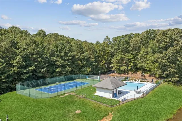 a view of a backyard with swimming pool