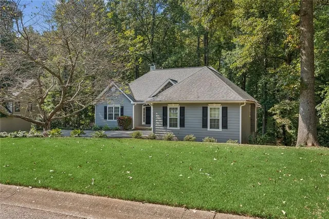a front view of house with yard and green space