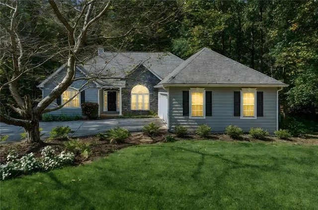 a front view of a house with a garden