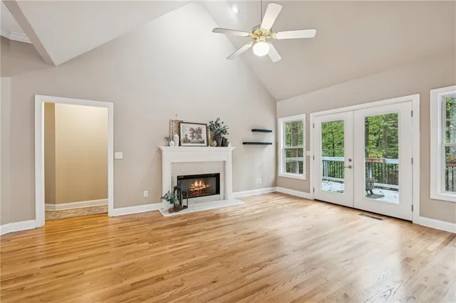 a view of an empty room with a fireplace and a window