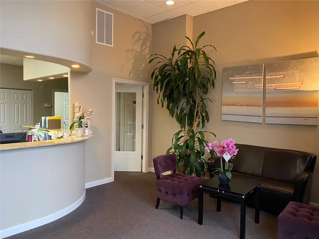 a living room with furniture and flowers
