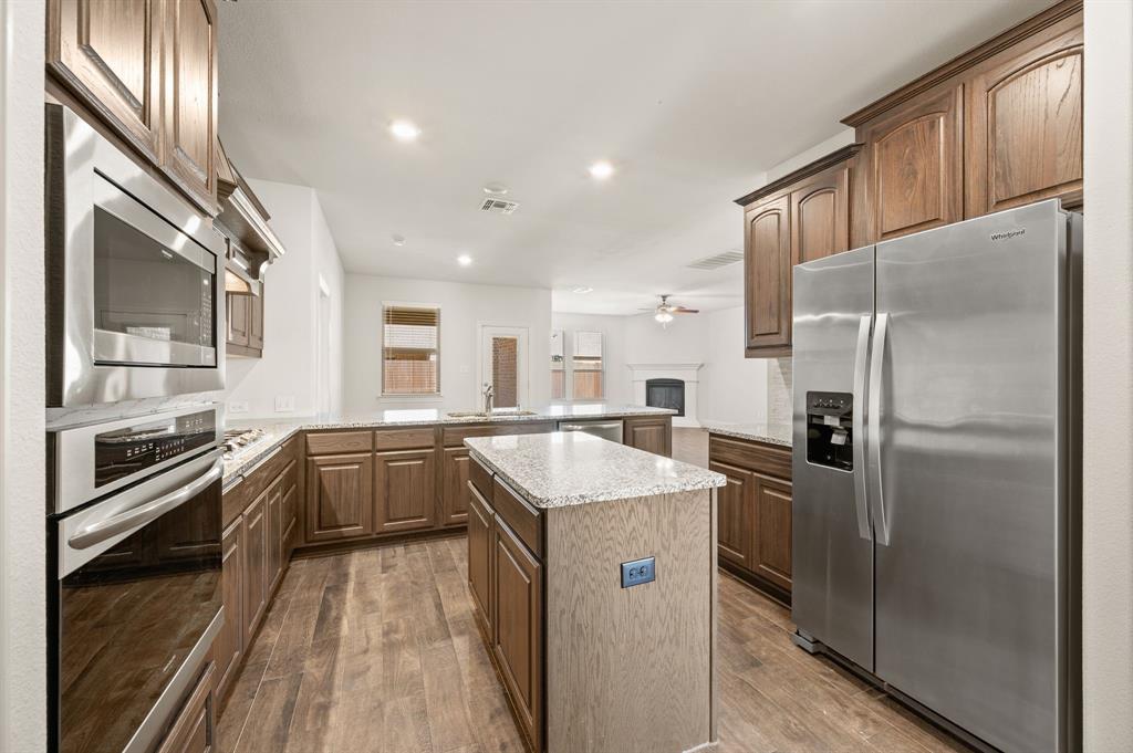 10920 Calvert Place McKinney, TX 75071 - Photo 13 of 37 a kitchen with a sink stove and refrigerator