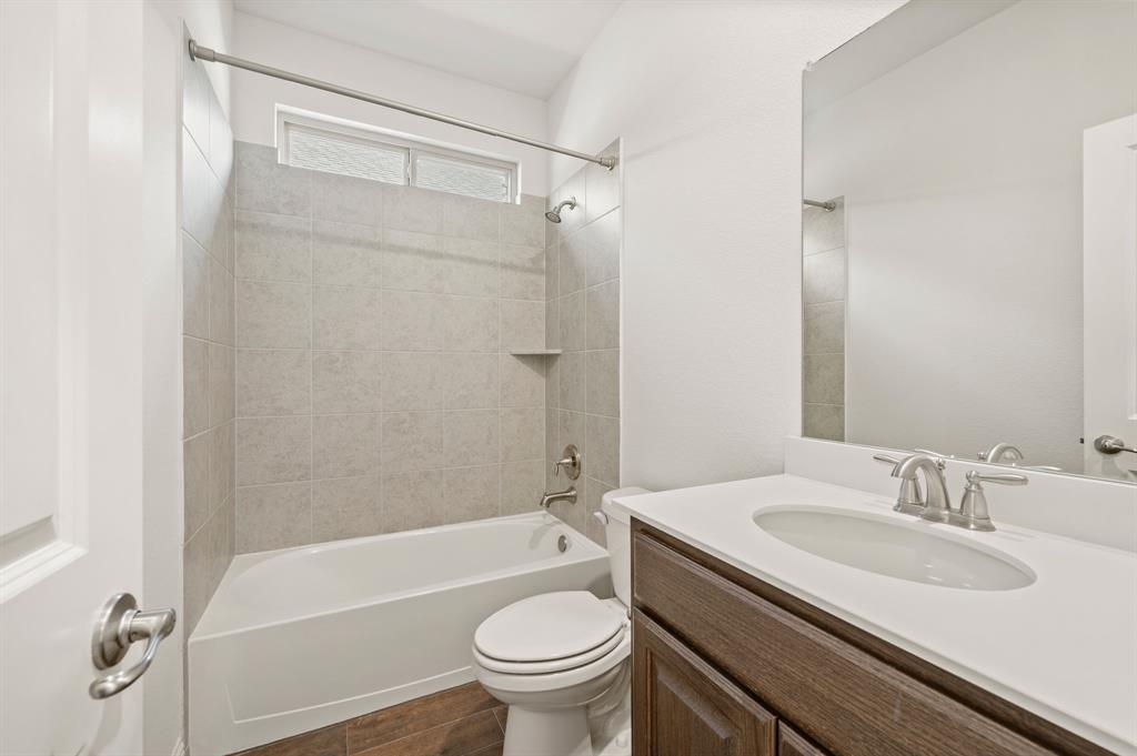10920 Calvert Place McKinney, TX 75071 - Photo 19 of 37 a bathroom with a sink toilet and shower