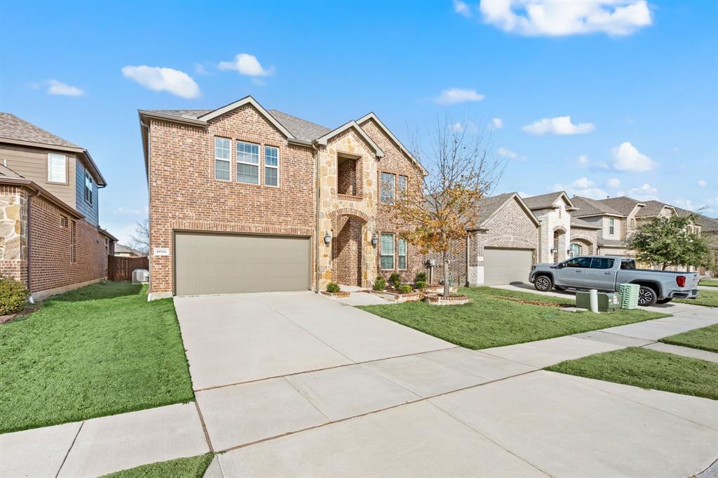 10920 Calvert Place McKinney, TX 75071 - Photo 2 of 37 a front view of a house with a yard and garage