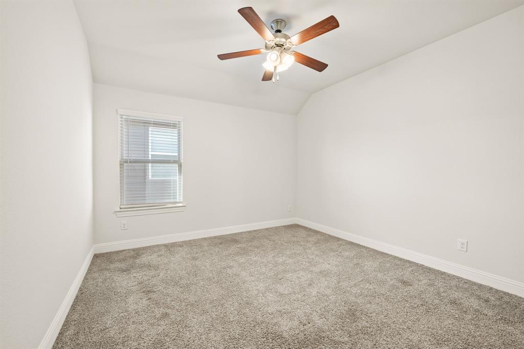 10920 Calvert Place McKinney, TX 75071 - Photo 23 of 37 an empty room with a window and a ceiling fan