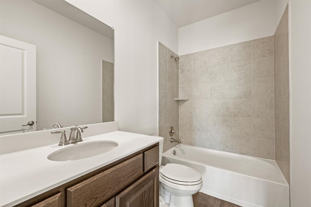 10920 Calvert Place McKinney, TX 75071 - Photo 24 of 37 a bathroom with a sink a toilet and a bathtub