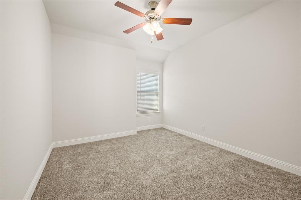 10920 Calvert Place McKinney, TX 75071 - Photo 25 of 37 an empty room with a window and a fan