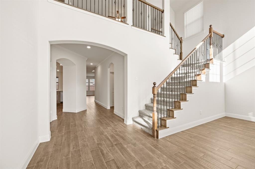 10920 Calvert Place McKinney, TX 75071 - Photo 5 of 37 a view of a hallway with wooden floor and entryway