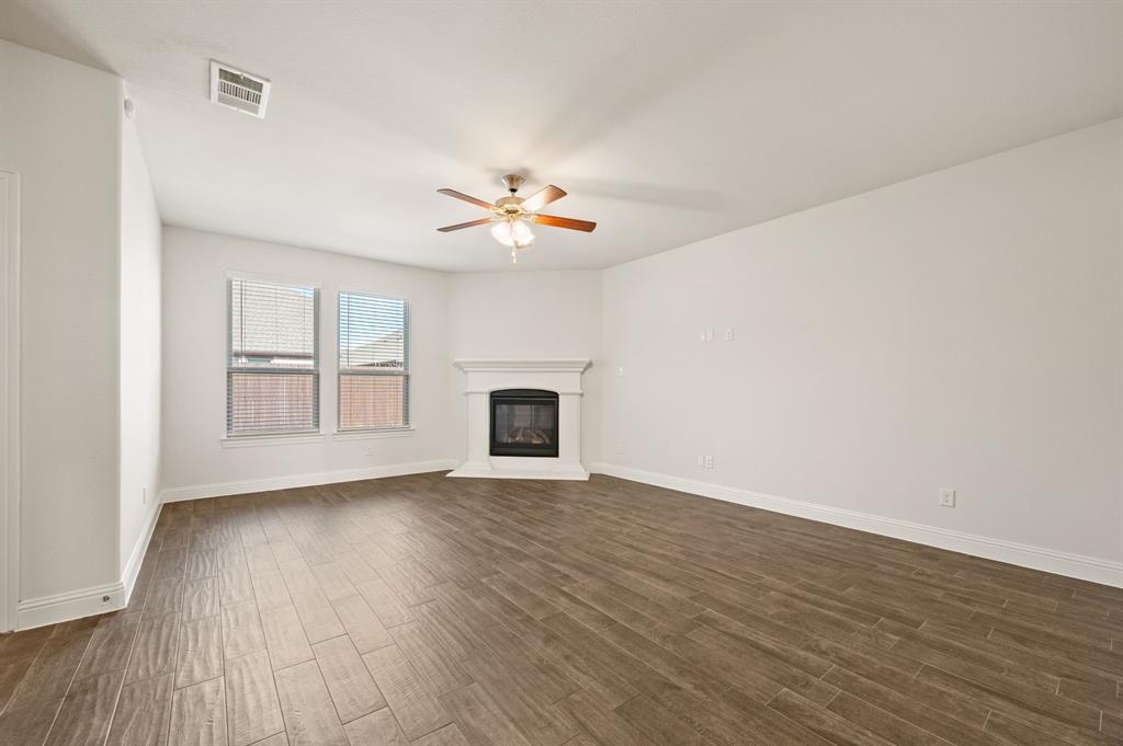10920 Calvert Place McKinney, TX 75071 - Photo 6 of 37 a view of an empty room with a window and wooden floor