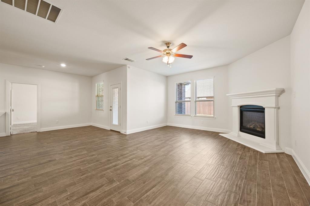 10920 Calvert Place McKinney, TX 75071 - Photo 7 of 37 a view of an empty room with a fireplace and a window